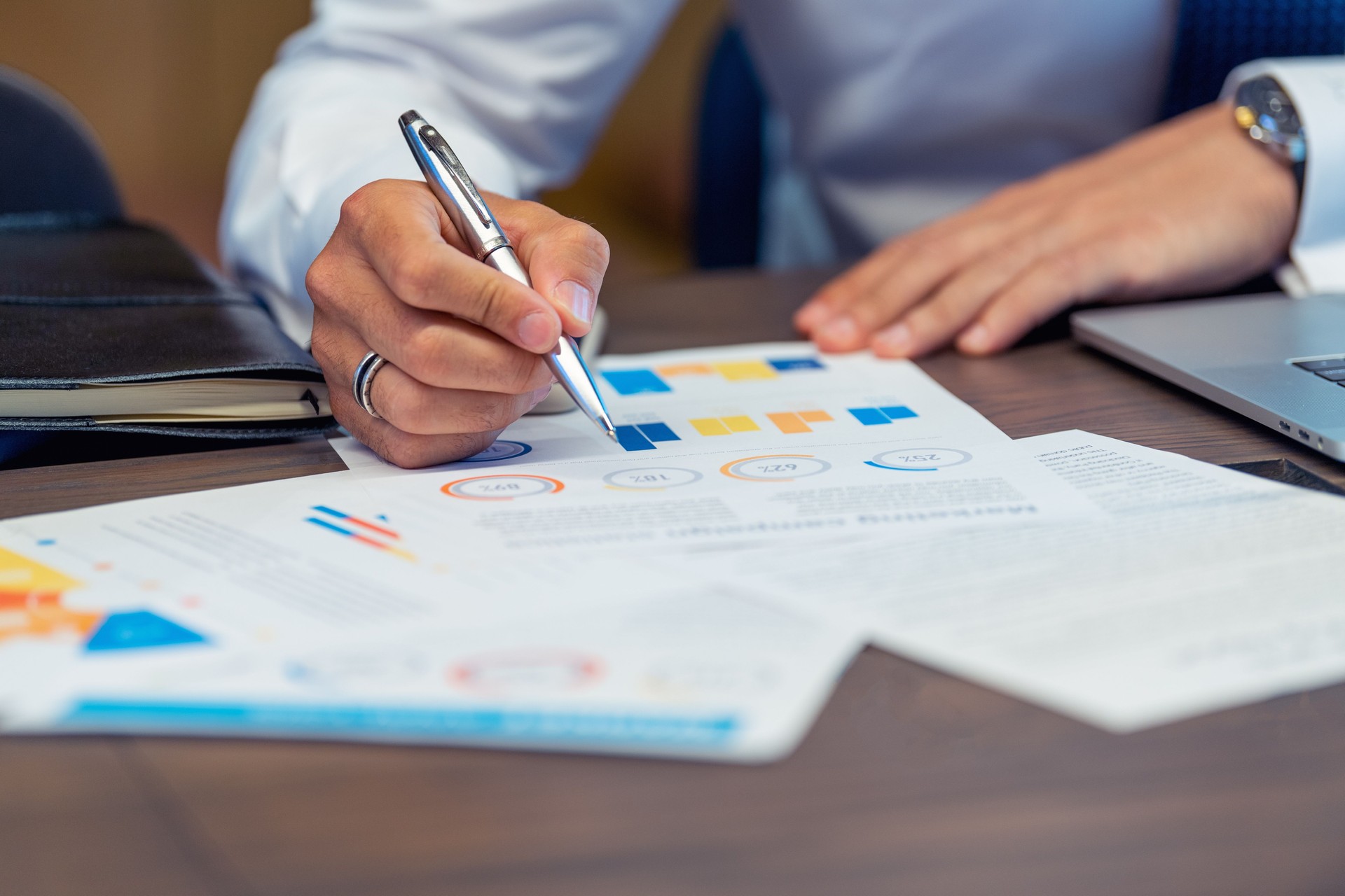 Close up of Business man working with documents with financial charts graphs and finance figures